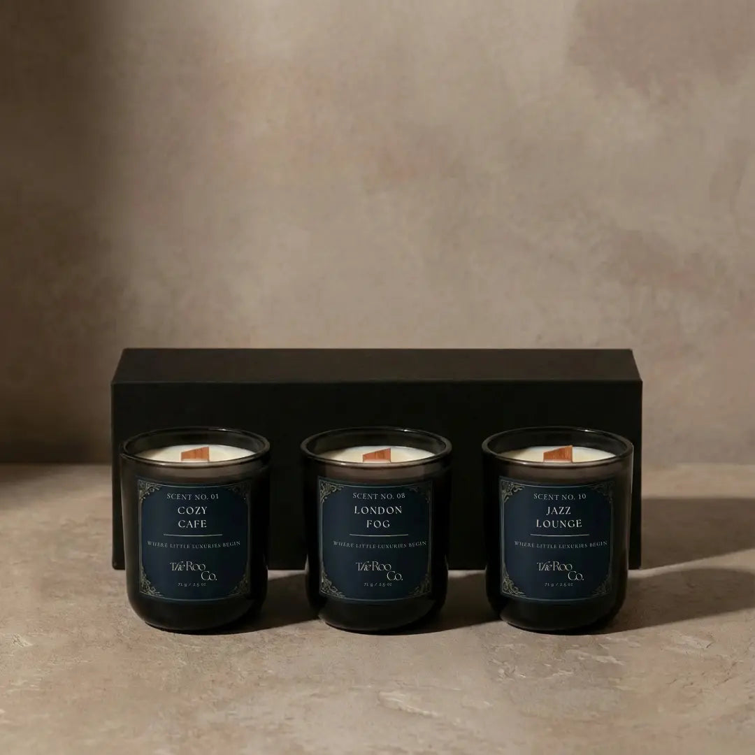 Luxury gourmand candles styled in a quiet café interior with subtle steam, warm tones, and an elegant, comforting mood.