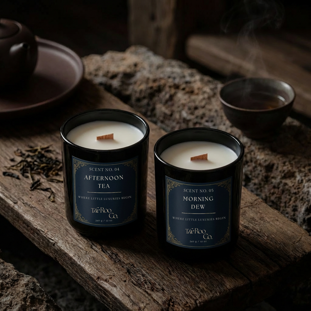 Fresh candle collection by The Roo Co featuring Afternoon Tea and Morning Dew, styled on weathered wood with soft steam, dried botanicals, and a calm, airy atmosphere.