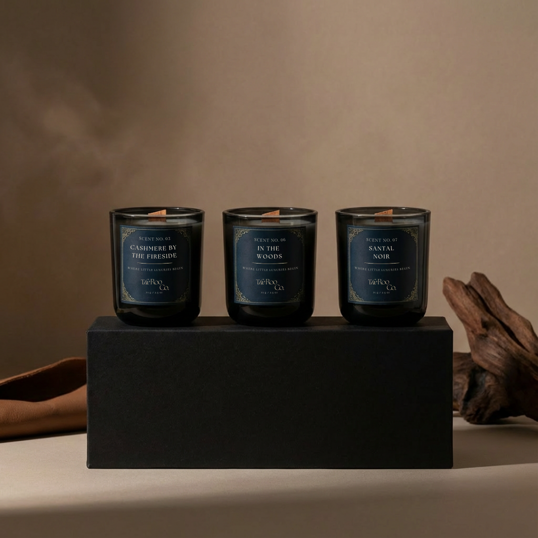 Woody discovery kit with three 2.5 oz mini candles: In the Woods, Santal Noir, and Cashmere by the Fireside