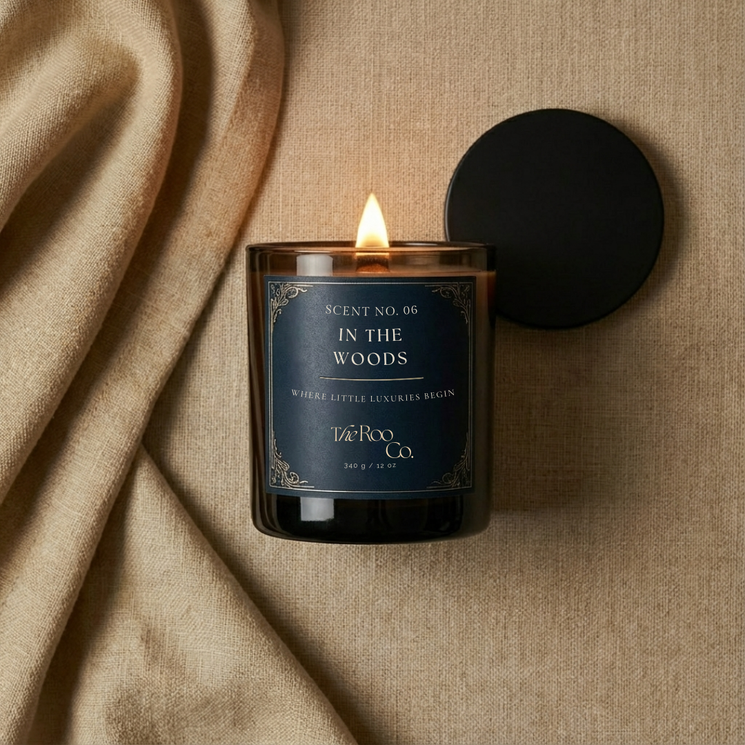 Flat lay of Lit wooden wick luxury scented candle creating warm ambient glow – In the Woods 
