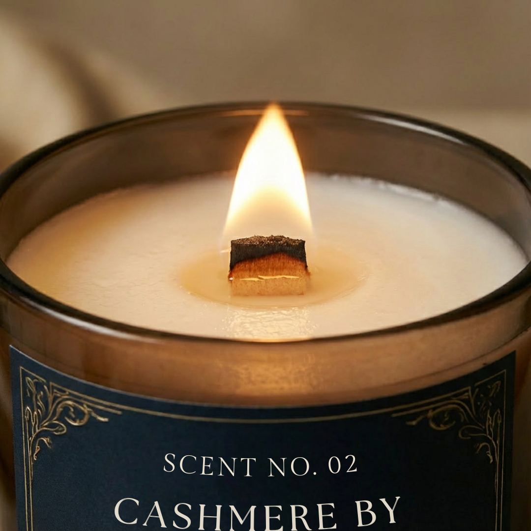 Lit wooden wick luxury scented candle creating warm ambient glow – Cashmere by the fireside