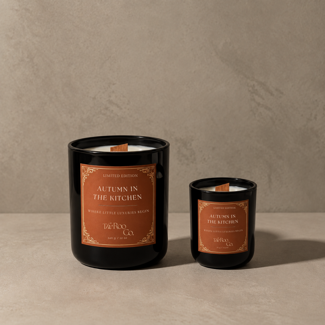 Autumn in the Kitchen scented candle in 12 oz and mini sizes by The Roo Co, shown together in glossy black glass vessels.