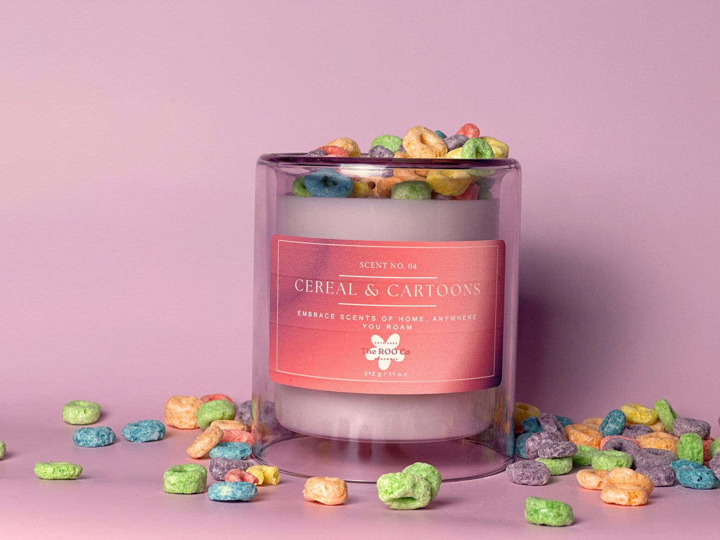 A luxury candle called cereal and cartoons that is 11 oz in a light violet vessel. In the background there is a bowl of fruit loops and a little jug of milk and a large golden spoon. Great for gifts for any occasion.