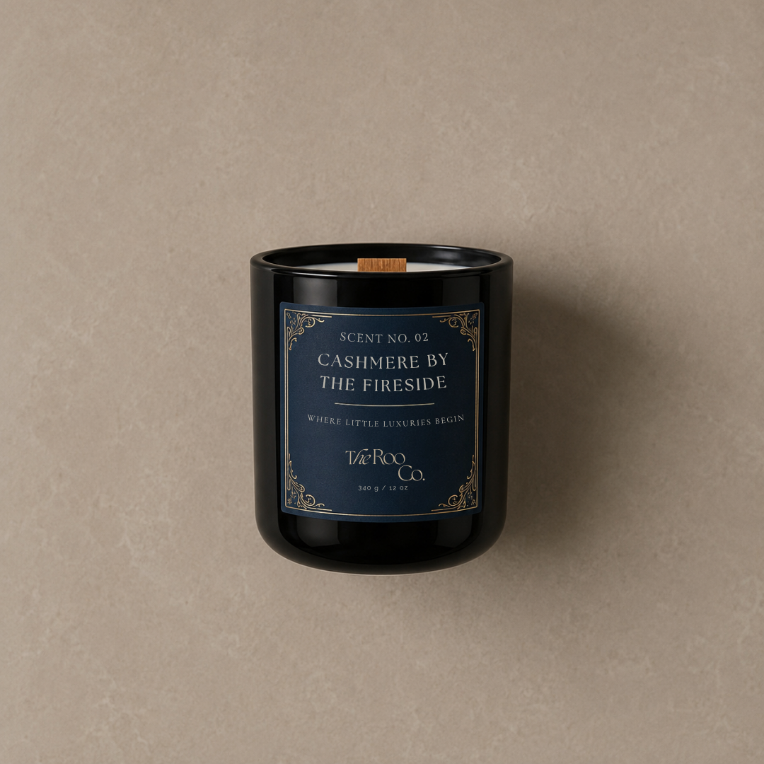 Close-up of luxury scented candle with wooden wick and gold label – Cashmere by the Fireside